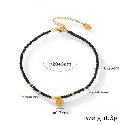 Fotlänk med svarta pärlor och berlock